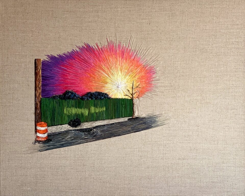 a vibrant sunrise peeks over a green fence. an orange construction barrel sits on the sidewalk in front