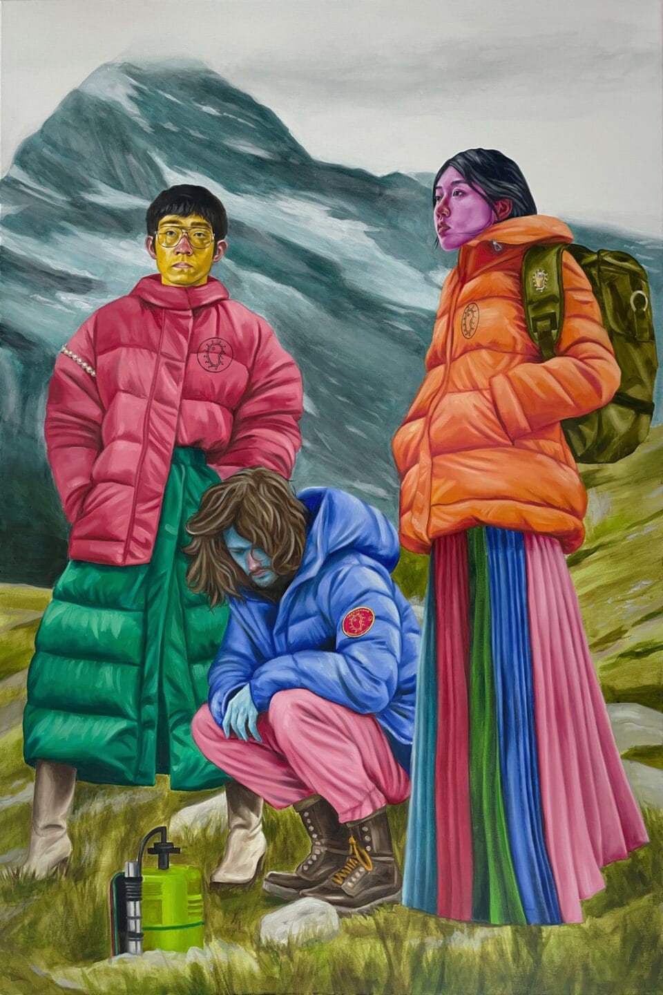 a trio of figures stand on the side of a mountain, each wearing brightly colored puffer jackets
