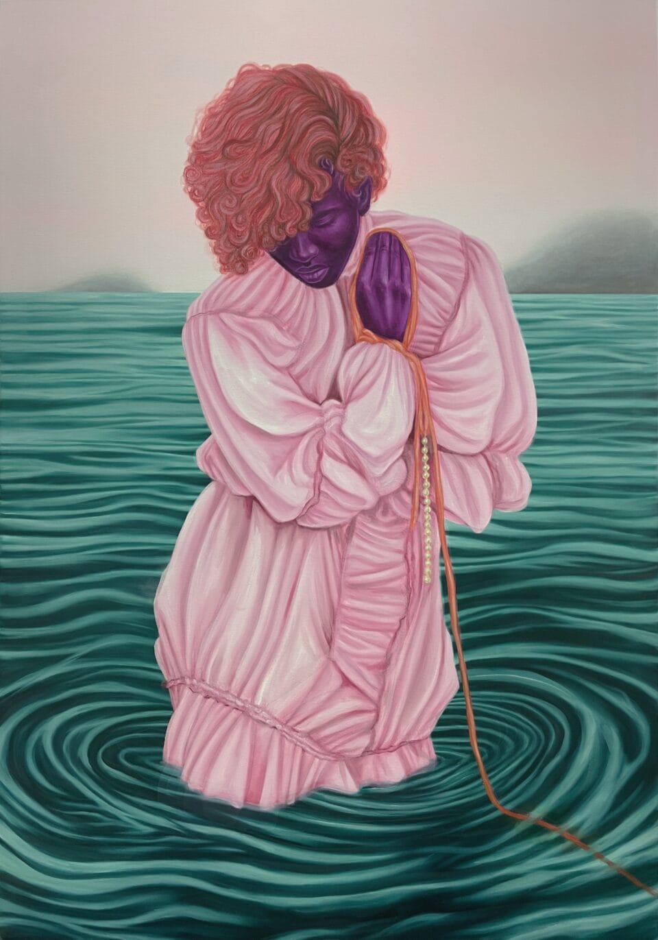 a figure wearing a pink one-piece garment, stands in a body of water, holds their hands up near their face, and looks downward