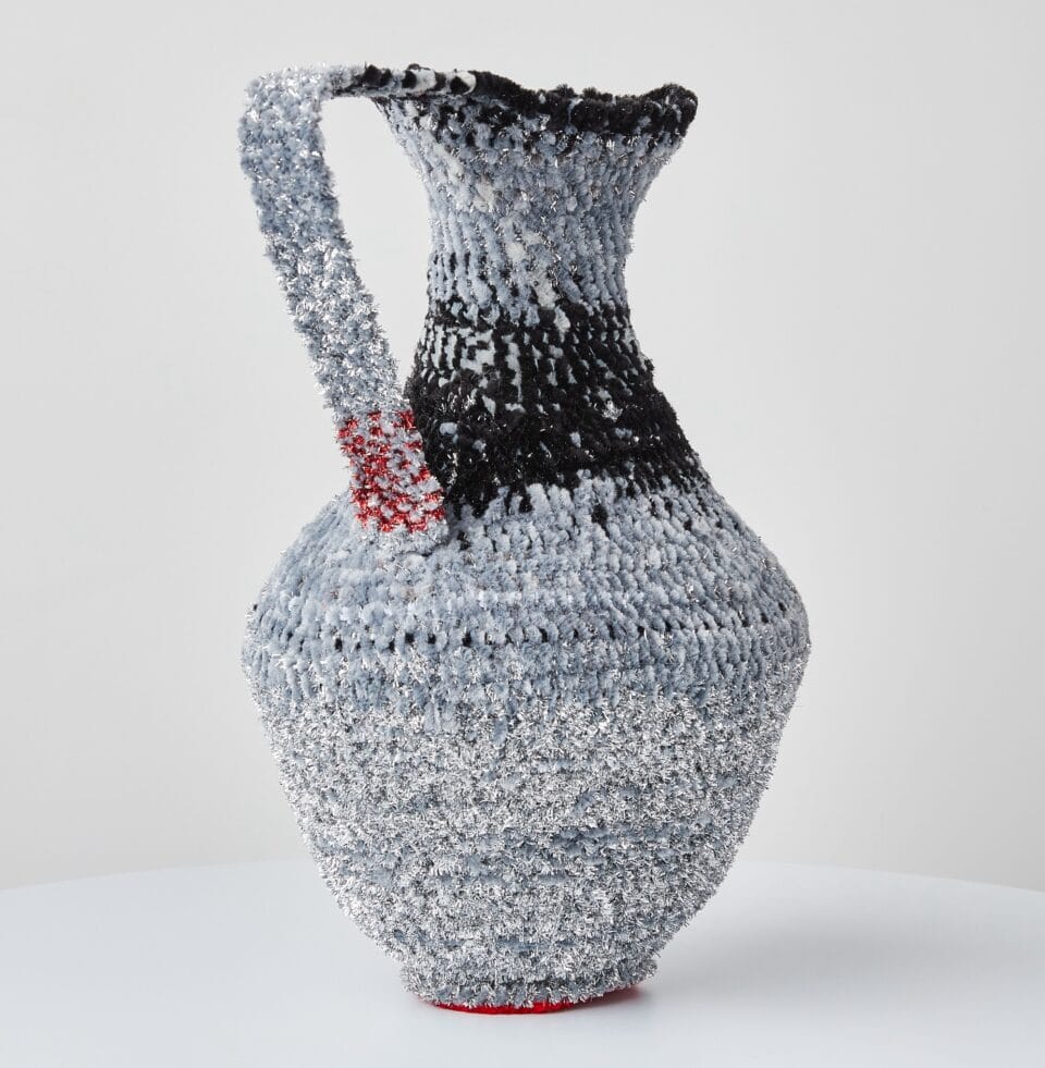 a vessel made from woven pipe cleaners in shades of gray and black