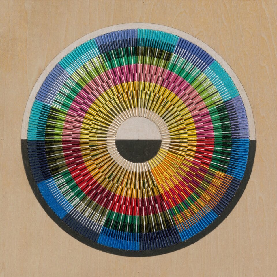 an abstract, geometric thread composition on a wood panel
