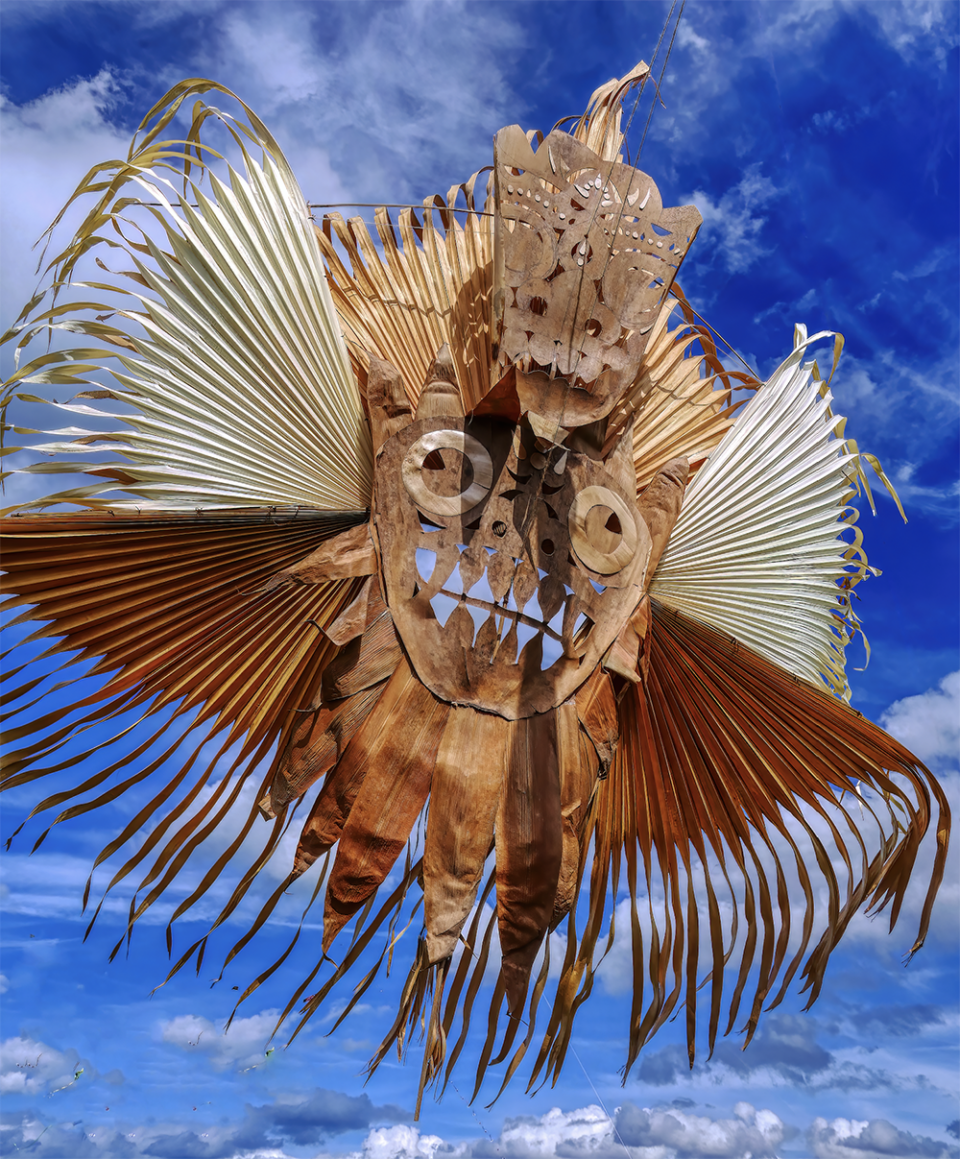 a figurative, mask like kite in the sky