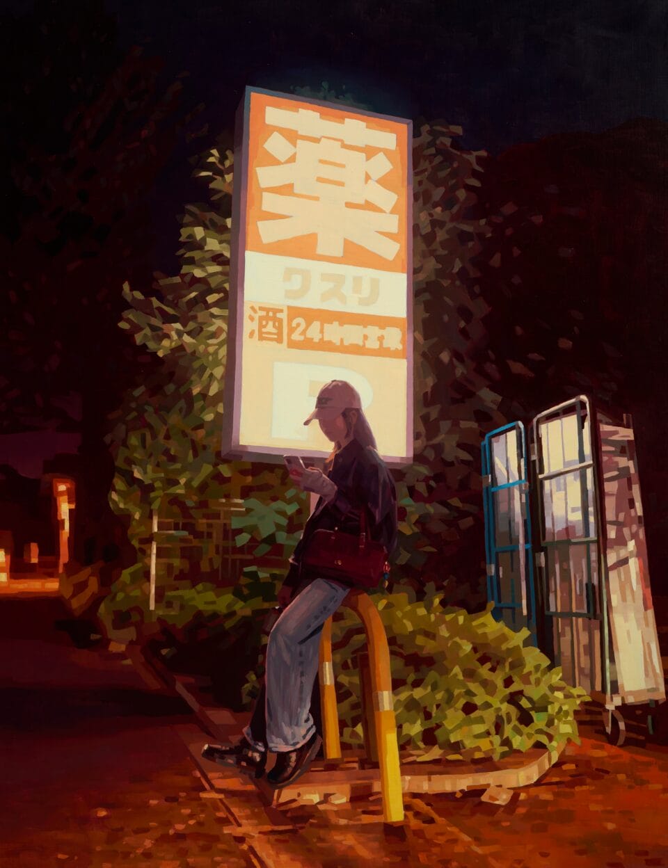 a person on their phone leans on a bike rack in front of a glowing sign