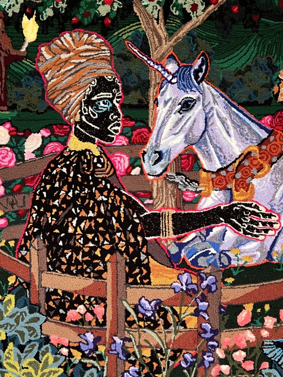 a hand-tufted embroidery composition of a Black woman with a scarf on her head, seated in a chair next to a unicorn, which she touches with her right hand