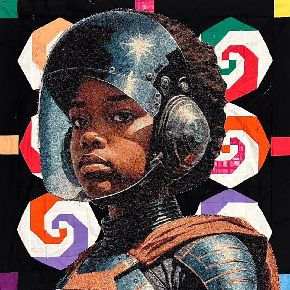 a portrait of a young girl with a helmet on in front of a vibrant patchwork style quilt