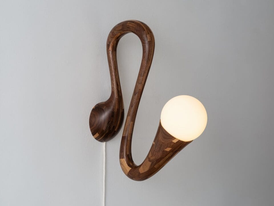 a wooden sconce made of small pieces of wood stacked together
