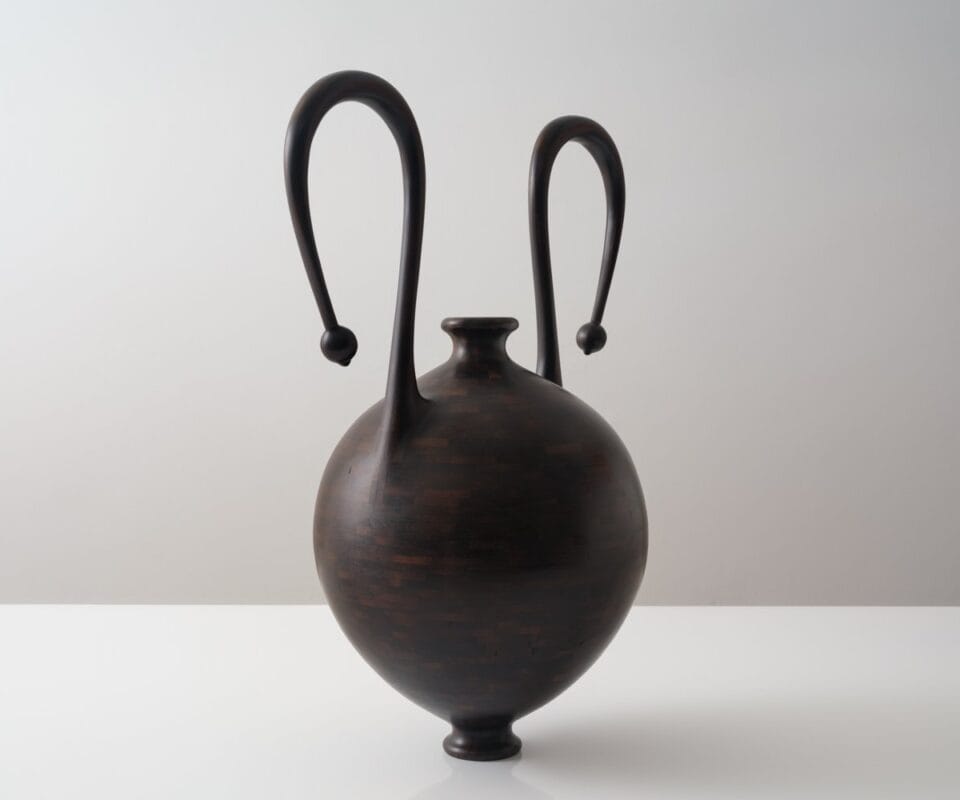 a wooden vessel with curved handles