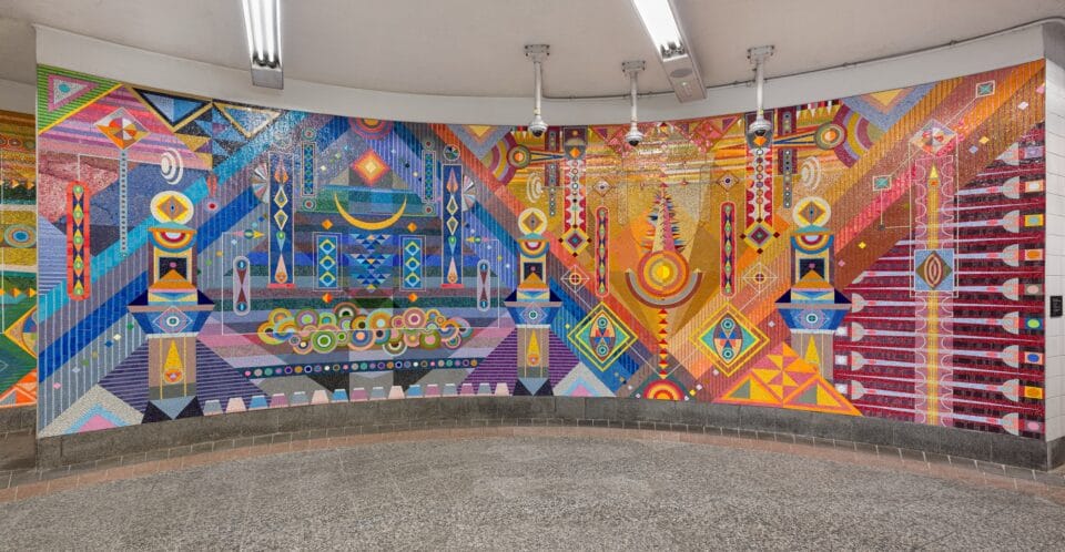 a vibrant geometric mural made of mosaic in the subway