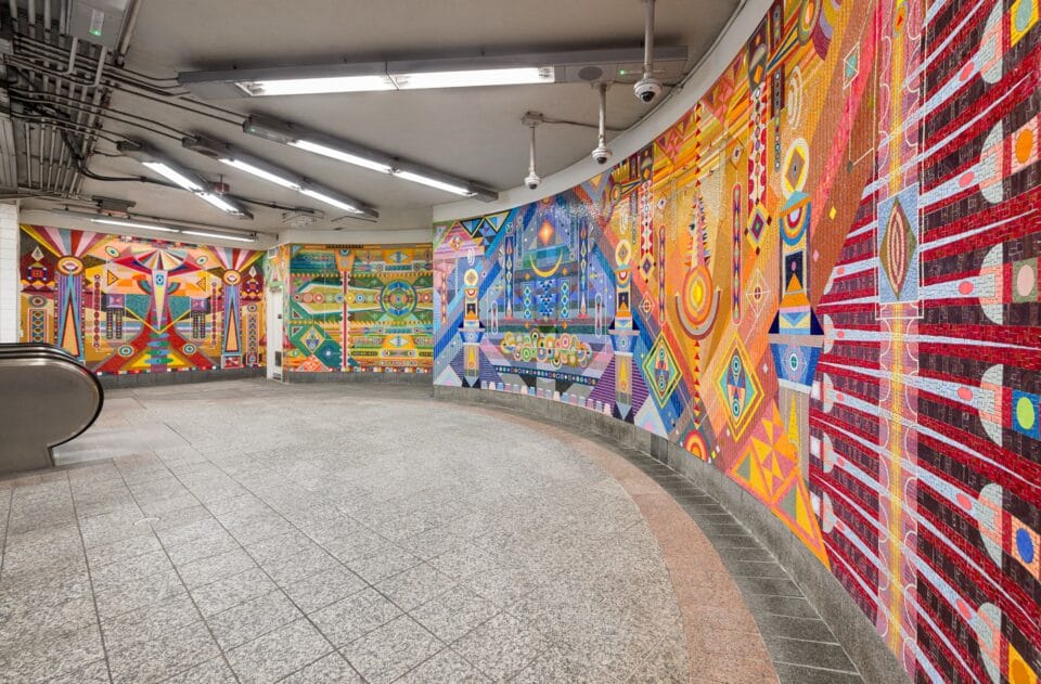 a vibrant geometric mural made of mosaic in the subway