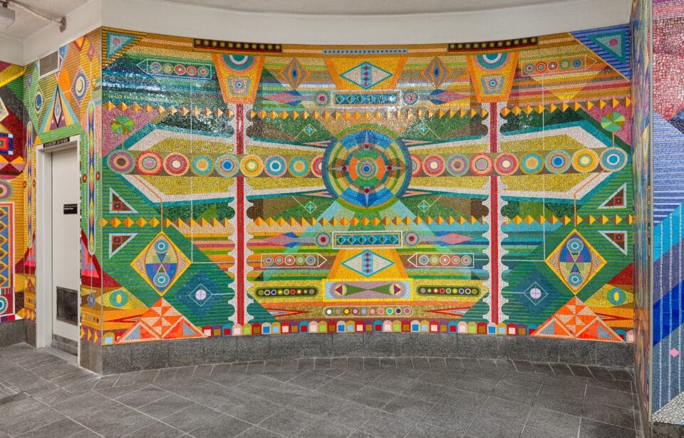a vibrant geometric mural made of mosaic in the subway