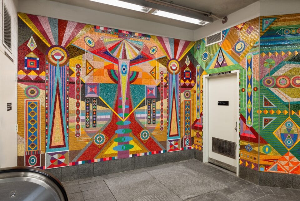 a vibrant geometric mural made of mosaic in the subway