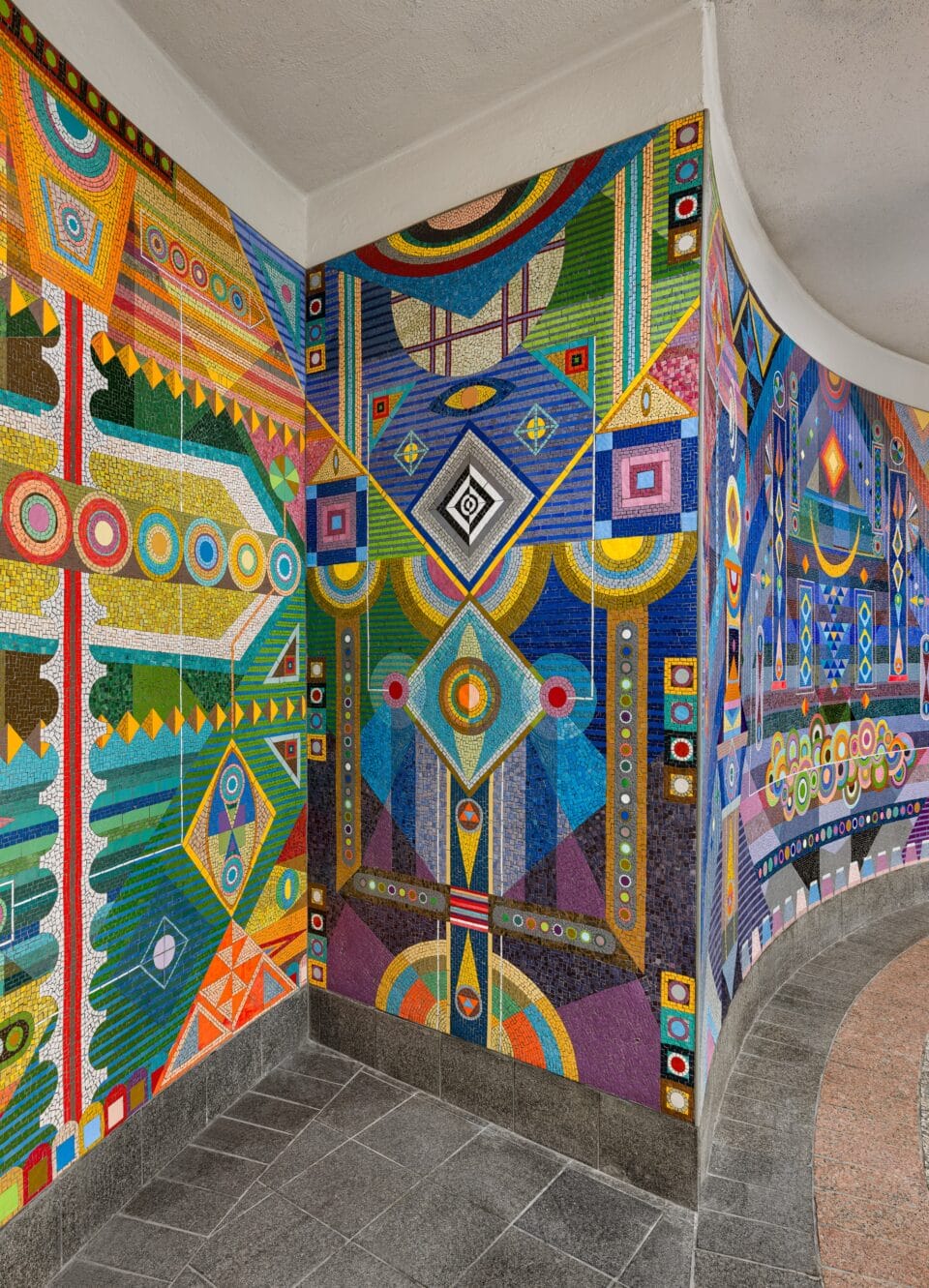 a vibrant geometric mural made of mosaic in the subway