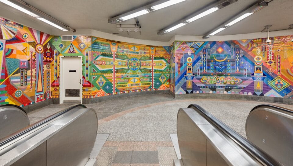 a vibrant geometric mural made of mosaic in the subway