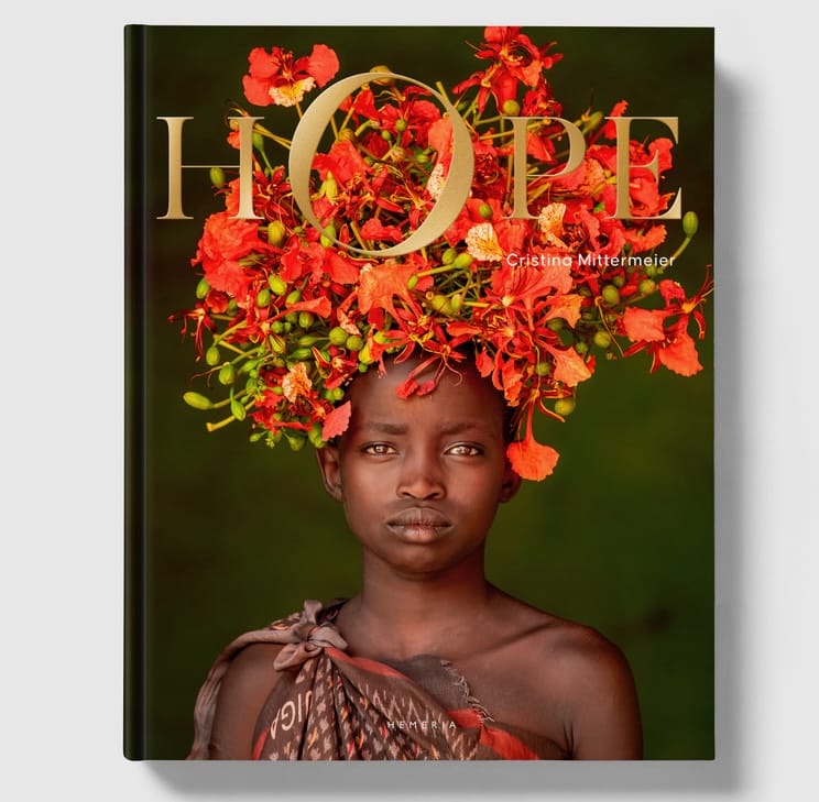 the cover of the book 'HOPE with a photograph of a Black woman wearing an elaborate orange-and-red floral headdress