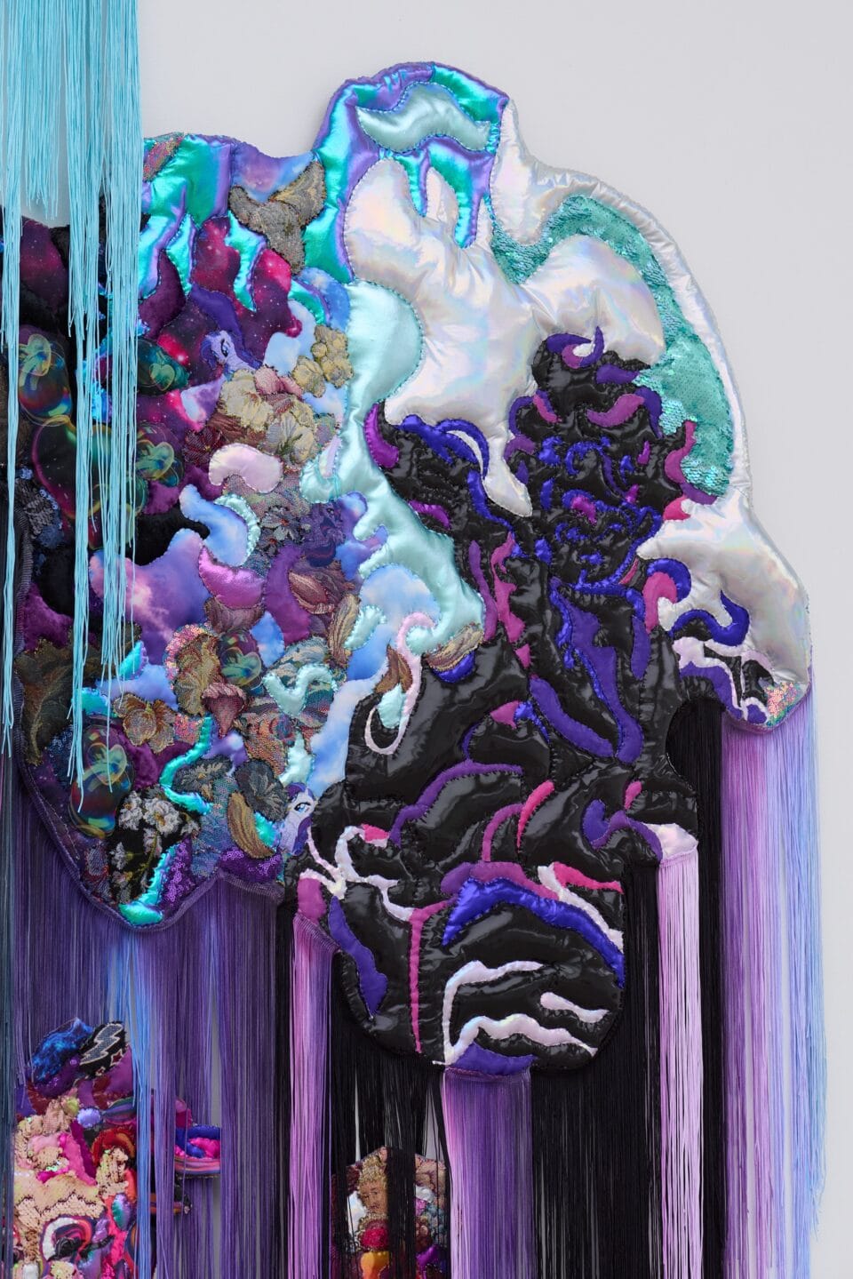 a detail of a monumental, abstract wall installation that appears to be cascading in purple, teal, and pink hues