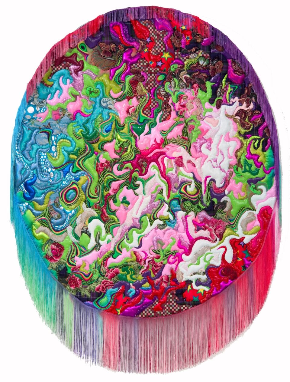 an abstract, oval composition made from quilted textile with a colorful fringe bordering the bottom